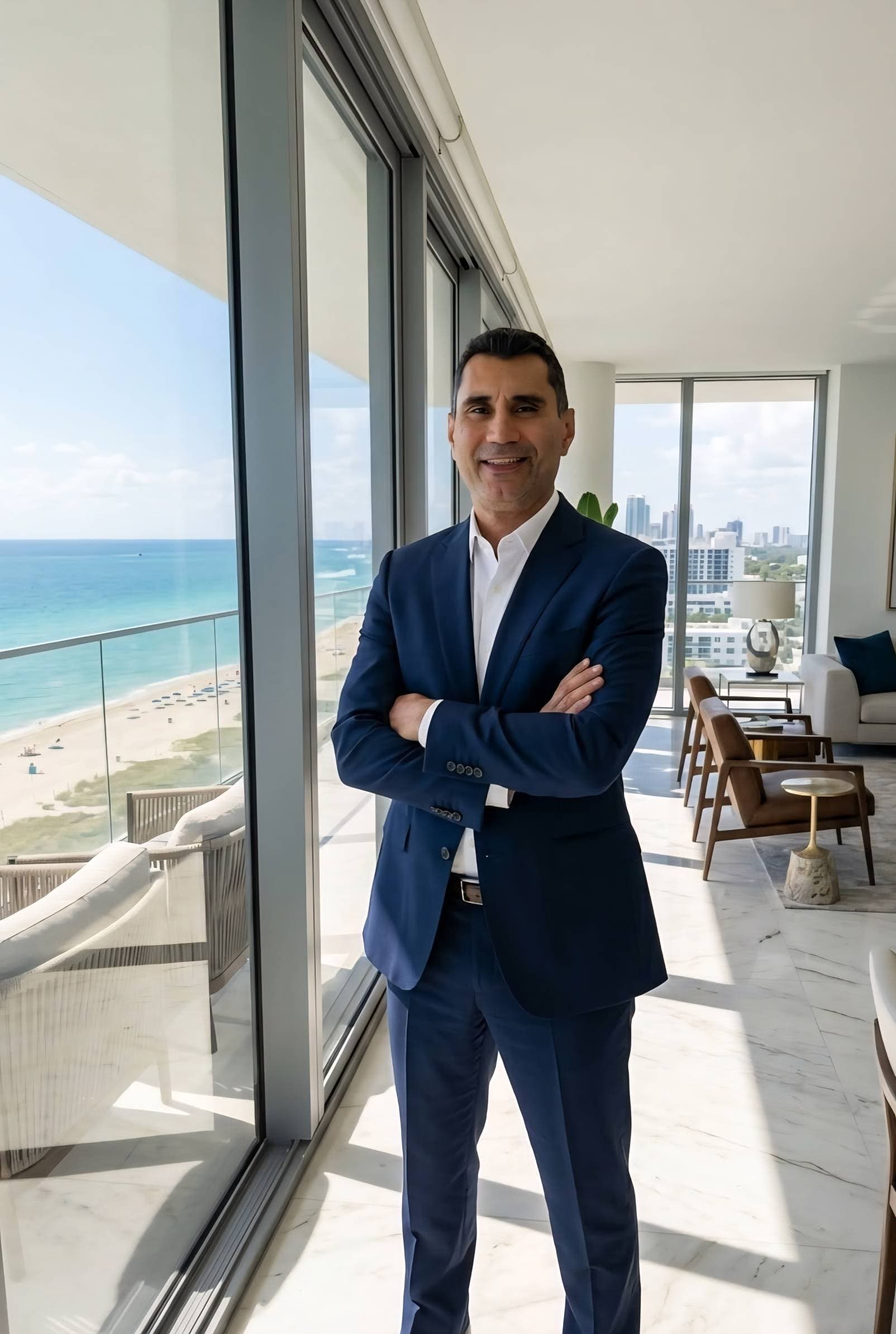 Andres Munoz, Andy Magic City Realtor, in a high-rise condo overlooking Miami Beach